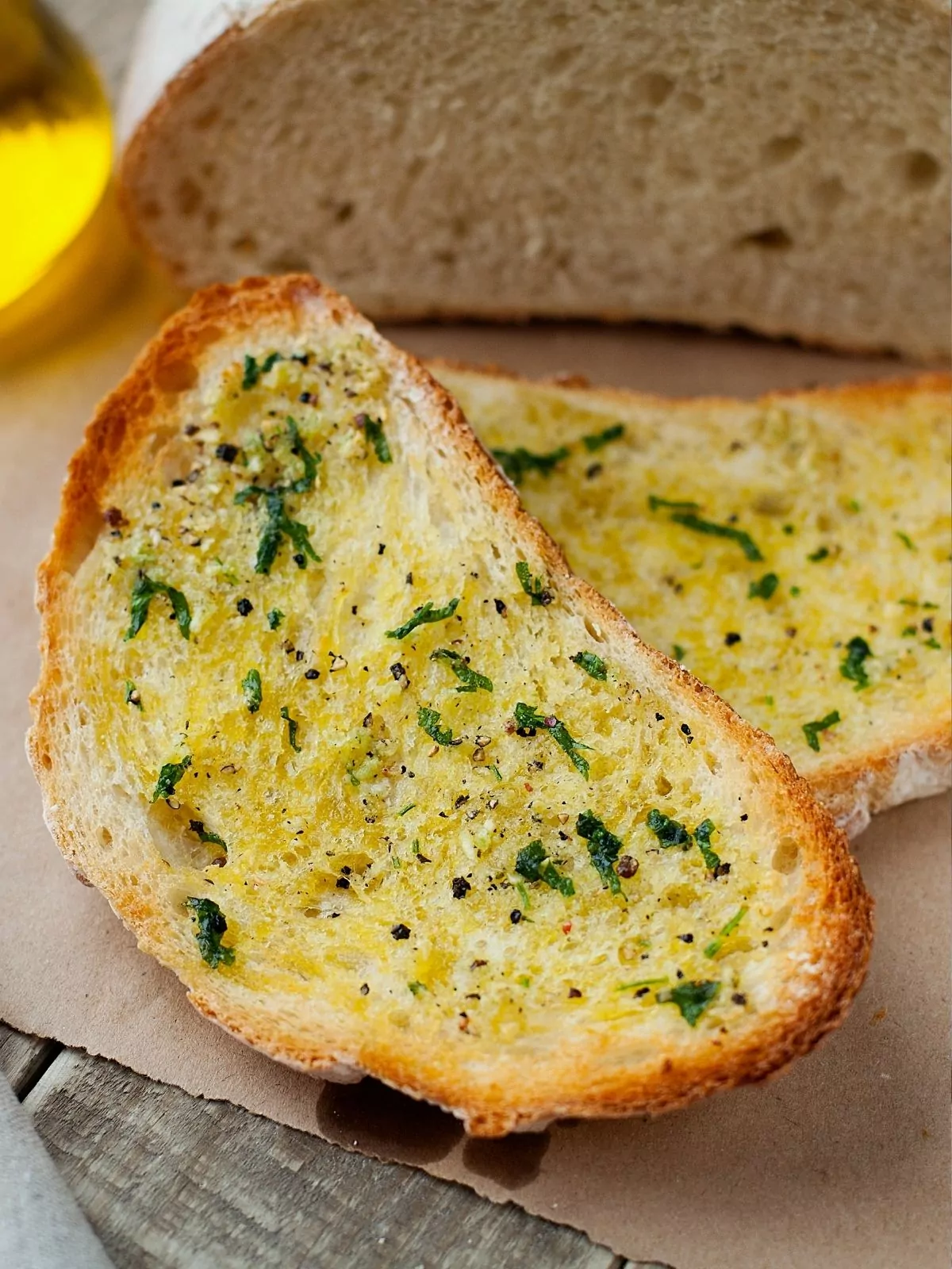 herb butter on slice toasted bread.
