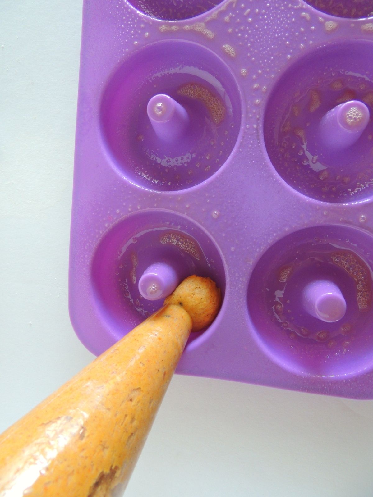pumpkin donut batter in decorating bag.