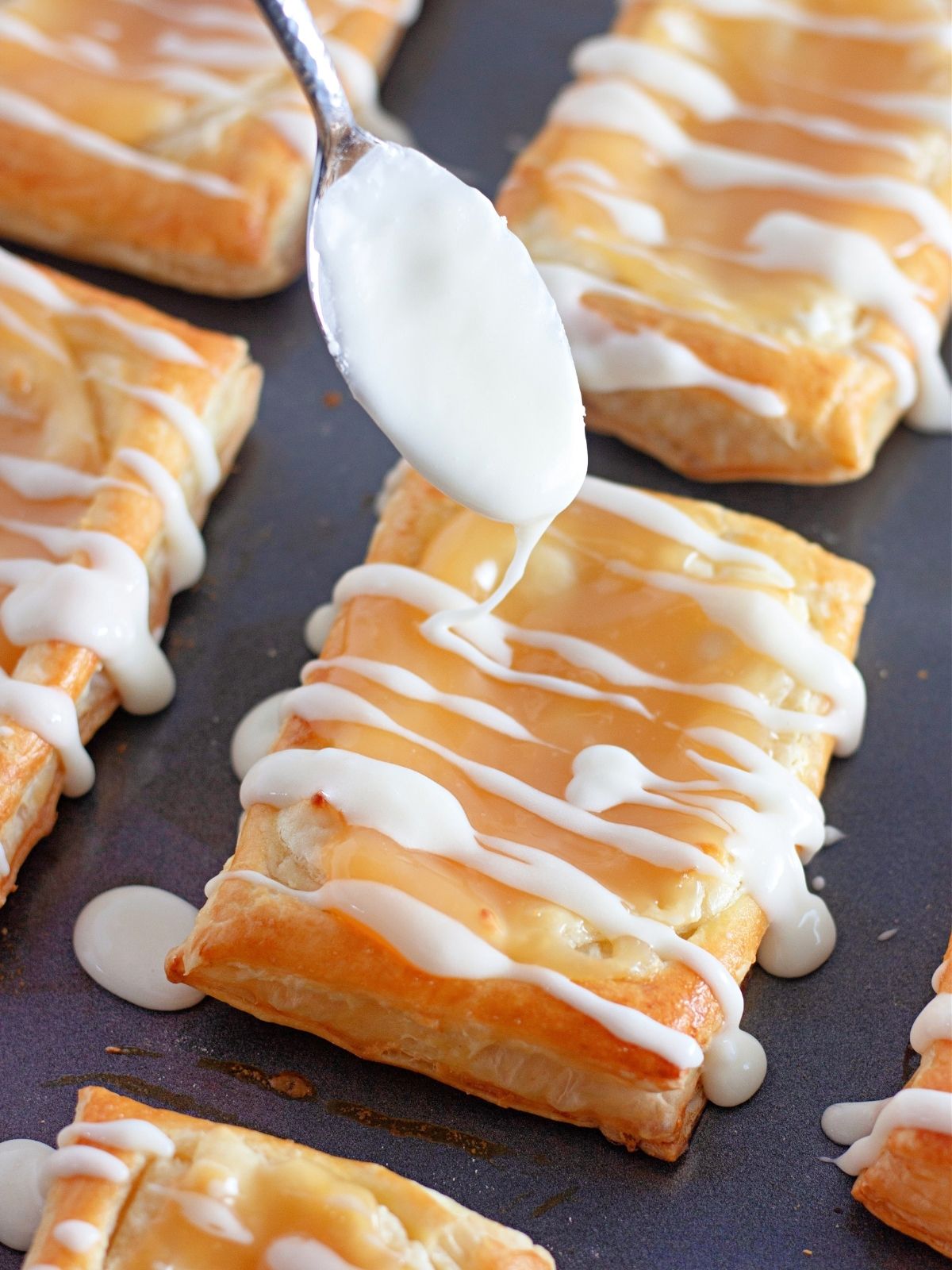 Puff pastry Danish baked with drizzled powdered sugar glaze.
