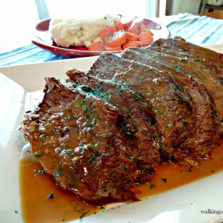 Sunday dinner pot roast on plate with gravy.
