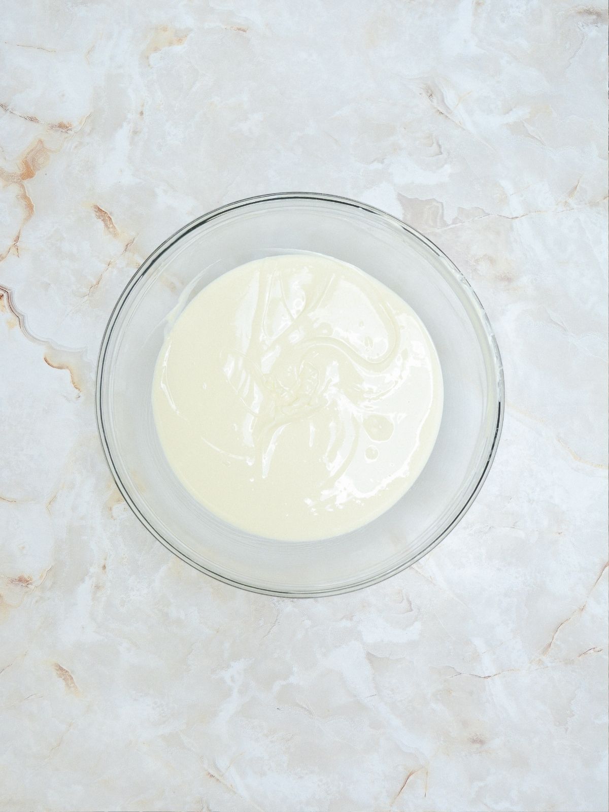 Melted white chocolate in bowl.