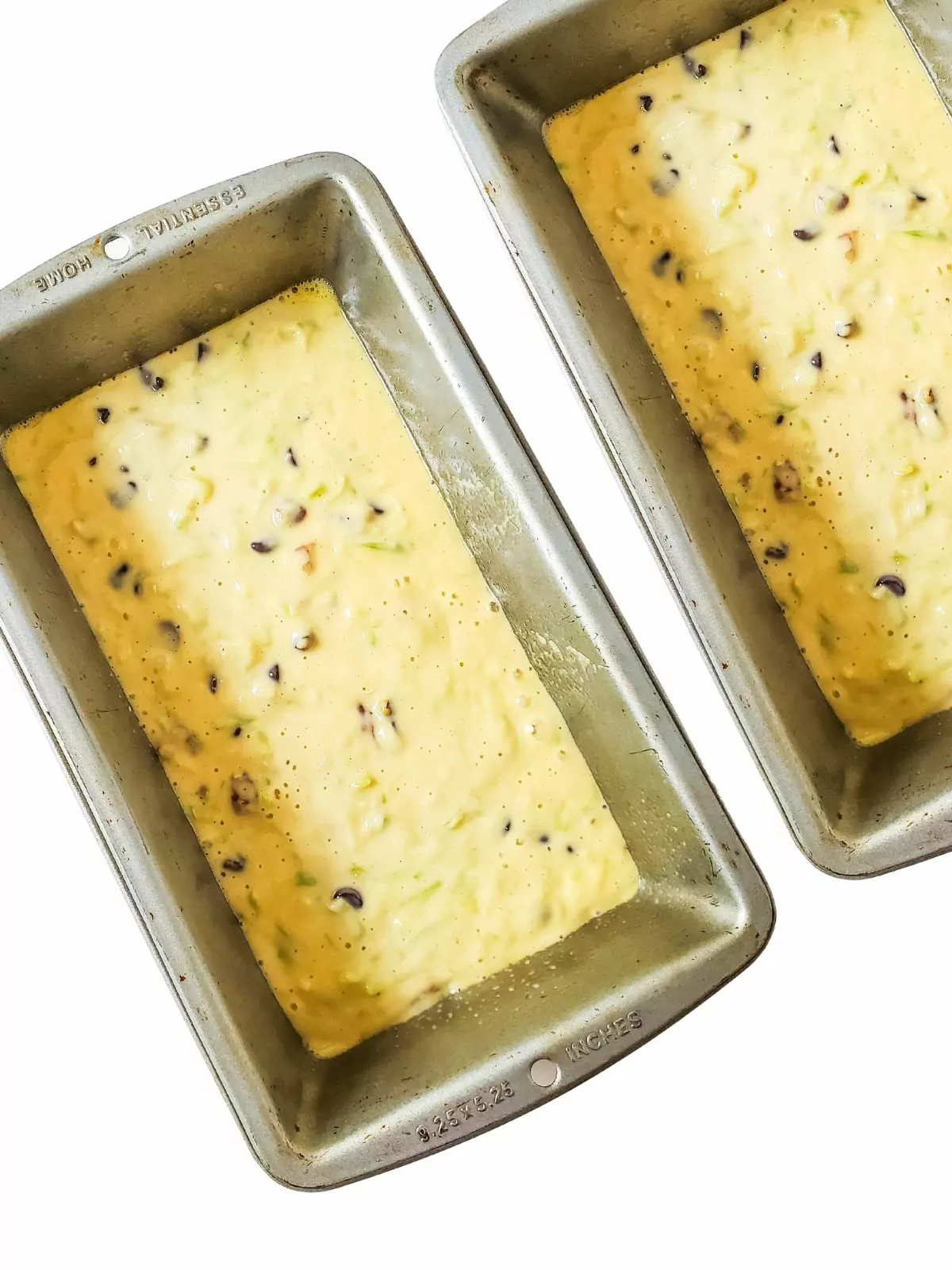 2 loaf pans of zucchini bread batter.