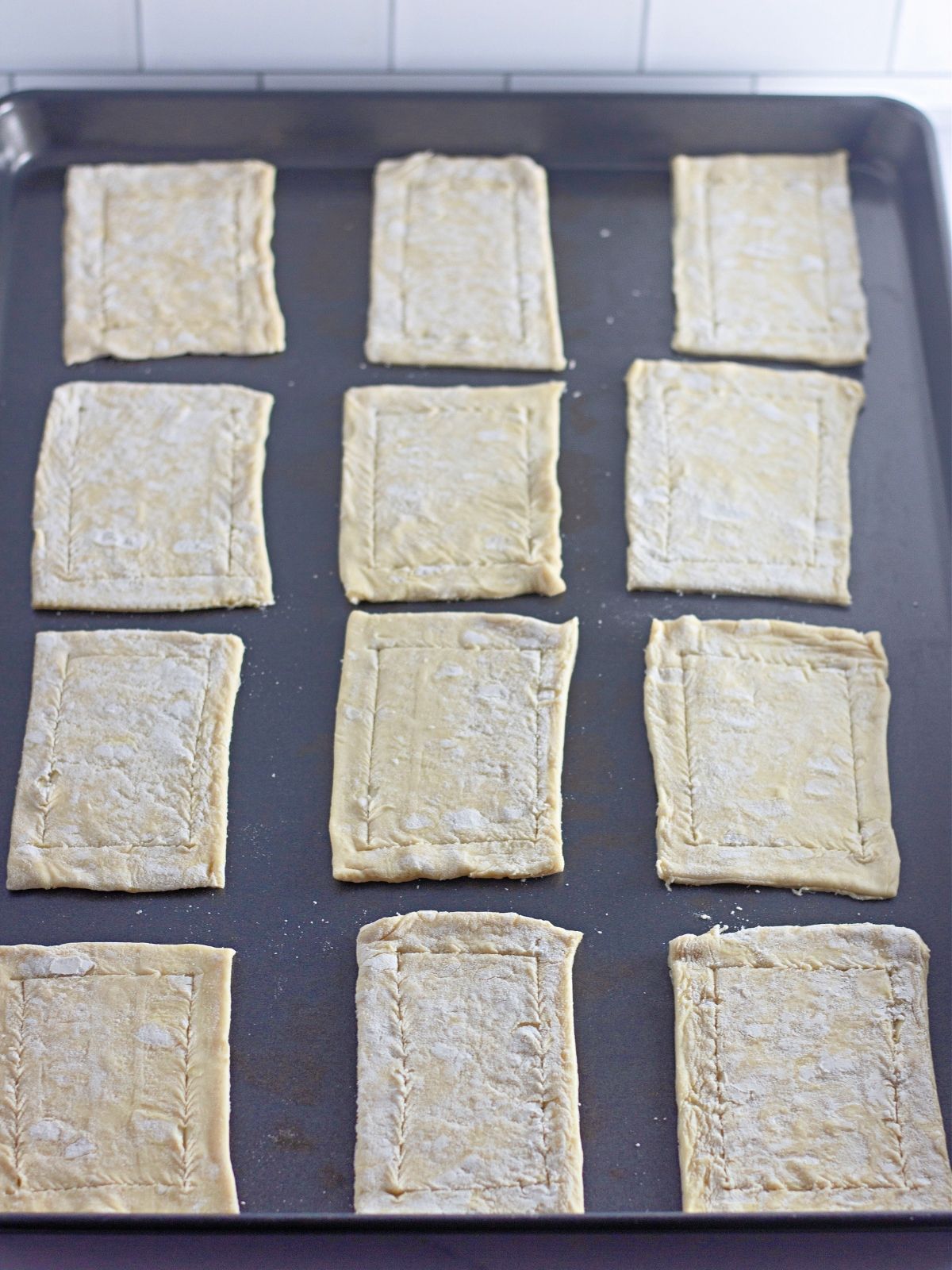 rectangles of puff pastry on baking tray before baking.