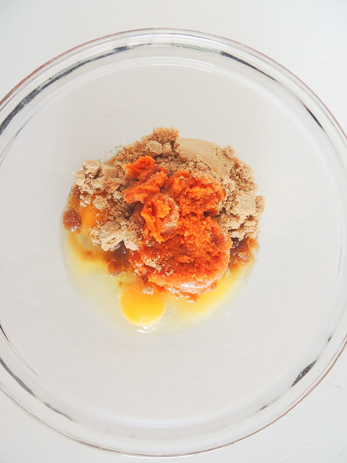 pumpkin puree, brown sugar, butter and eggs in bowl.