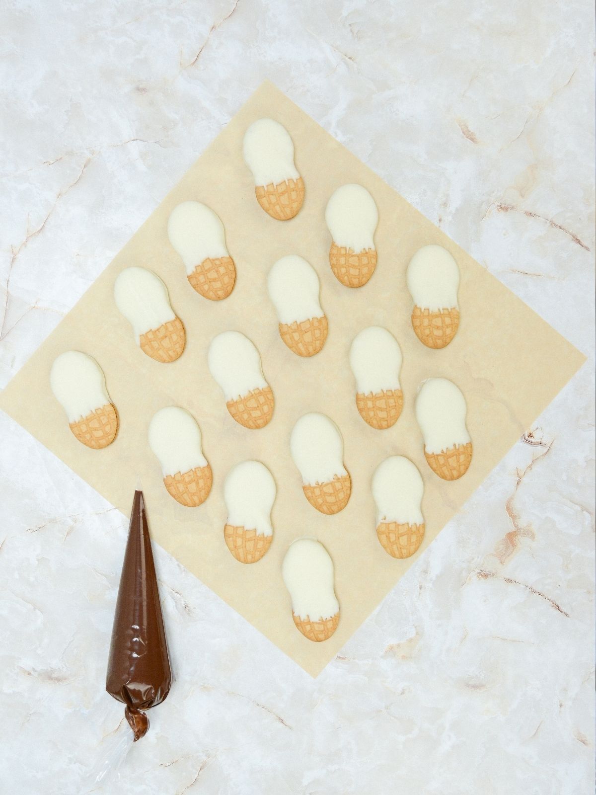 melted chocolate in plastic bag with Nutter Butter cookies dipped in white melted chocolate.