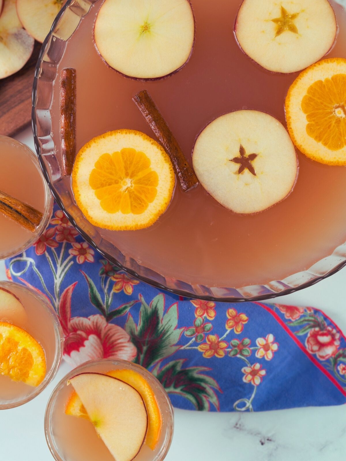 apple cider Christmas punch in bowl with glasses.