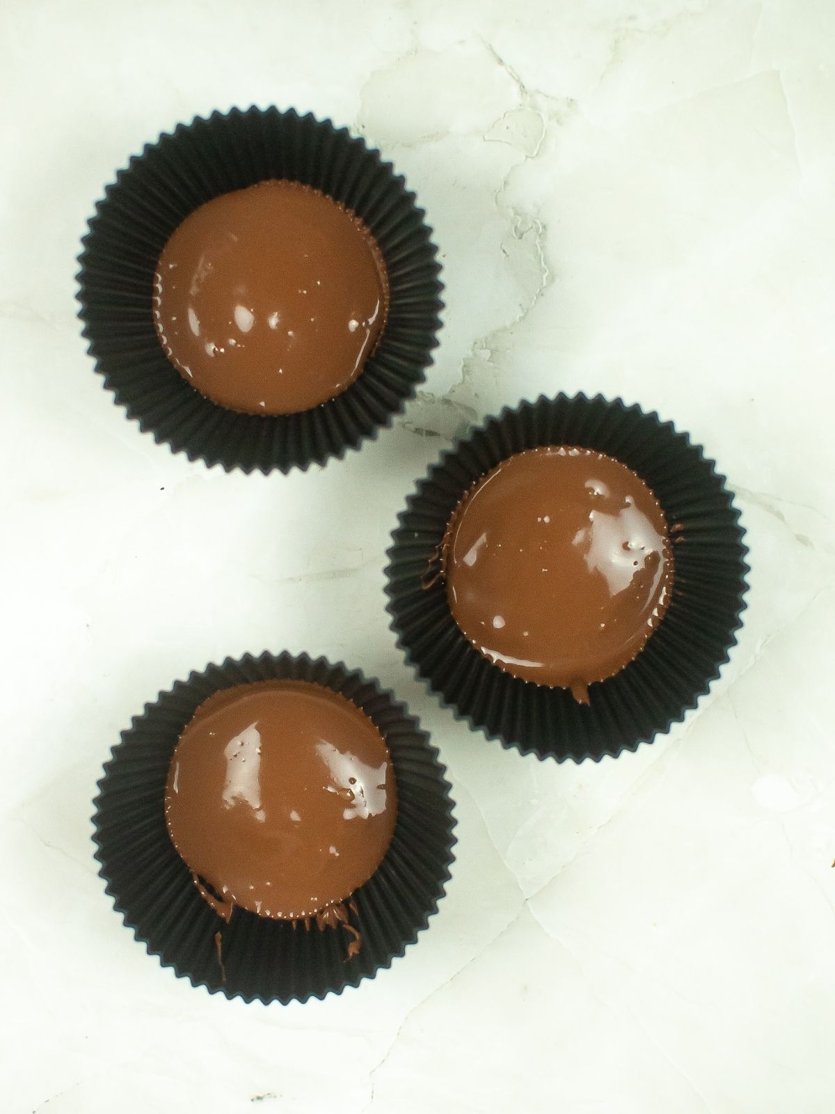 melted chocolate in silicone muffin cups.