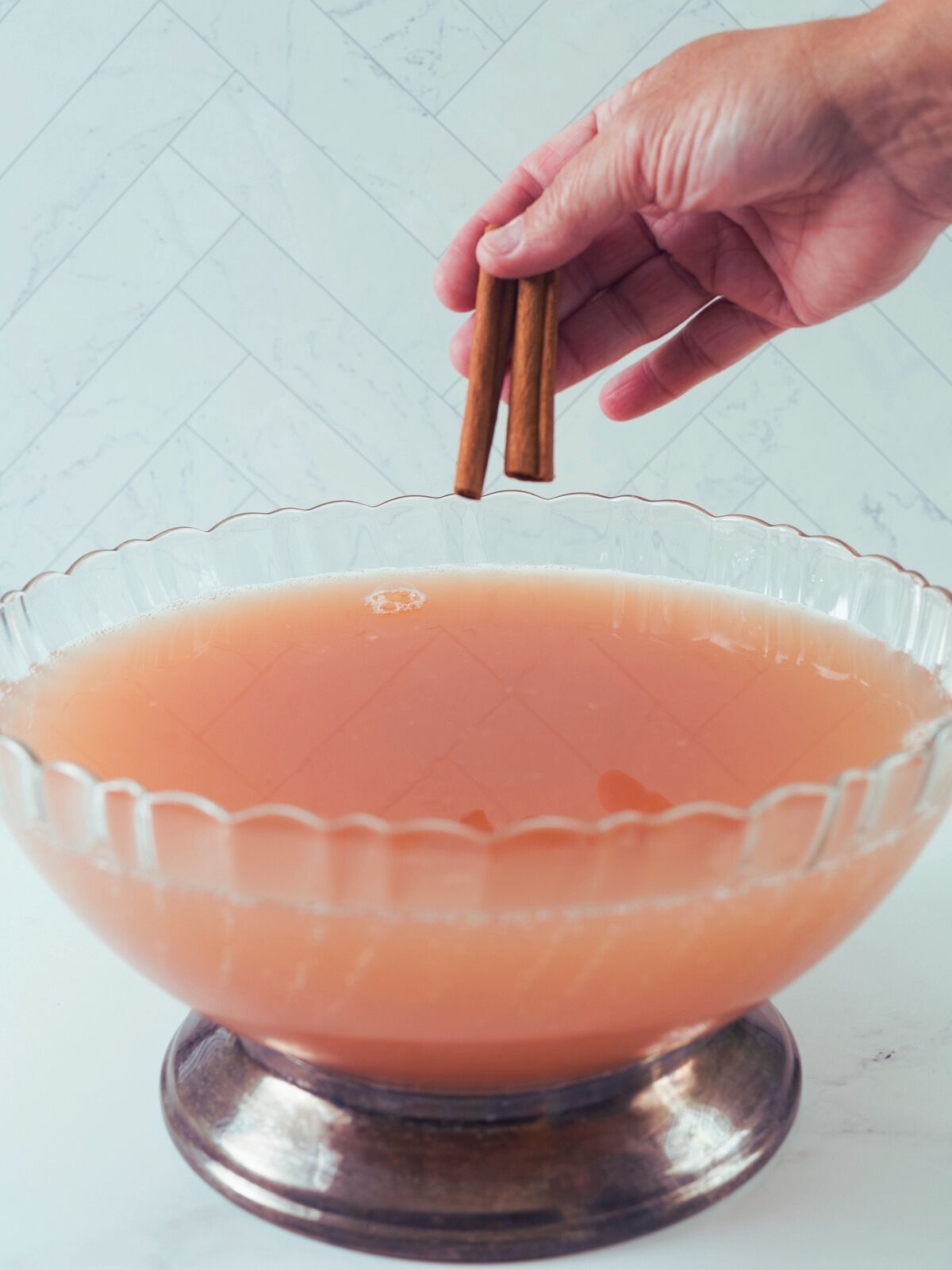 Add cinnamon sticks to punch bowl.