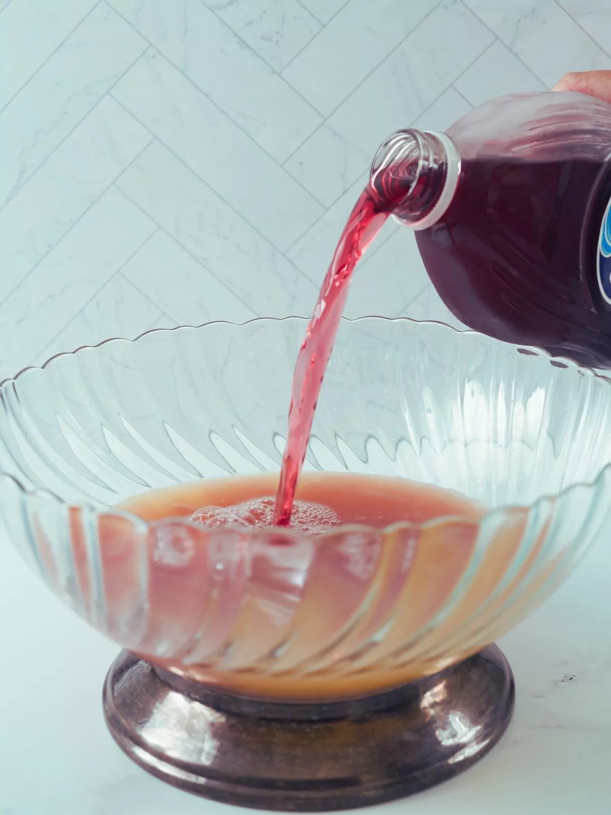 add cranberry juice to punch bowl.