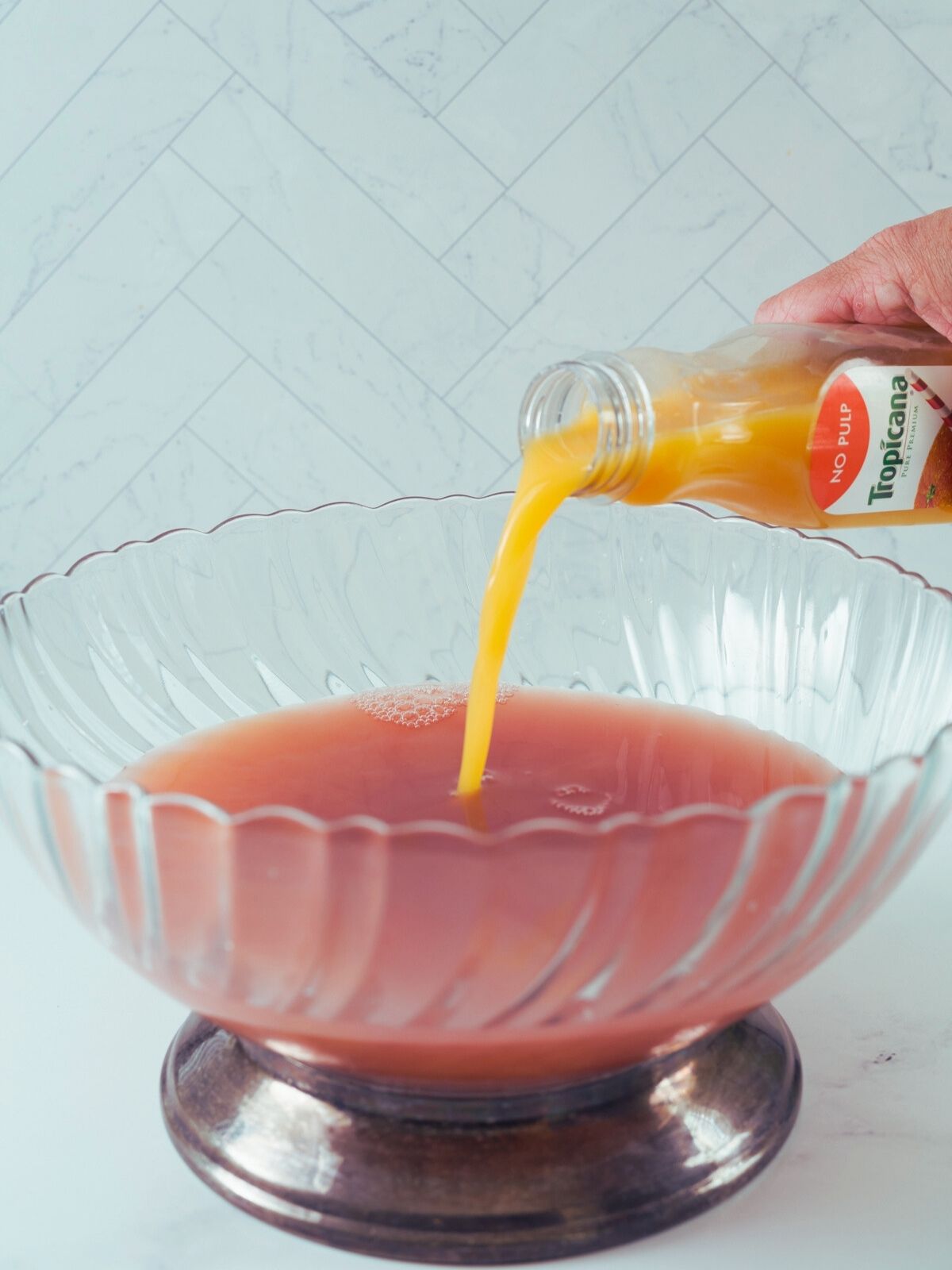 Add orange juice to punch bowl.
