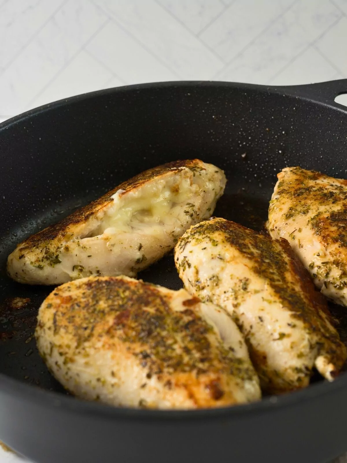 browned chicken breasts with herbs.