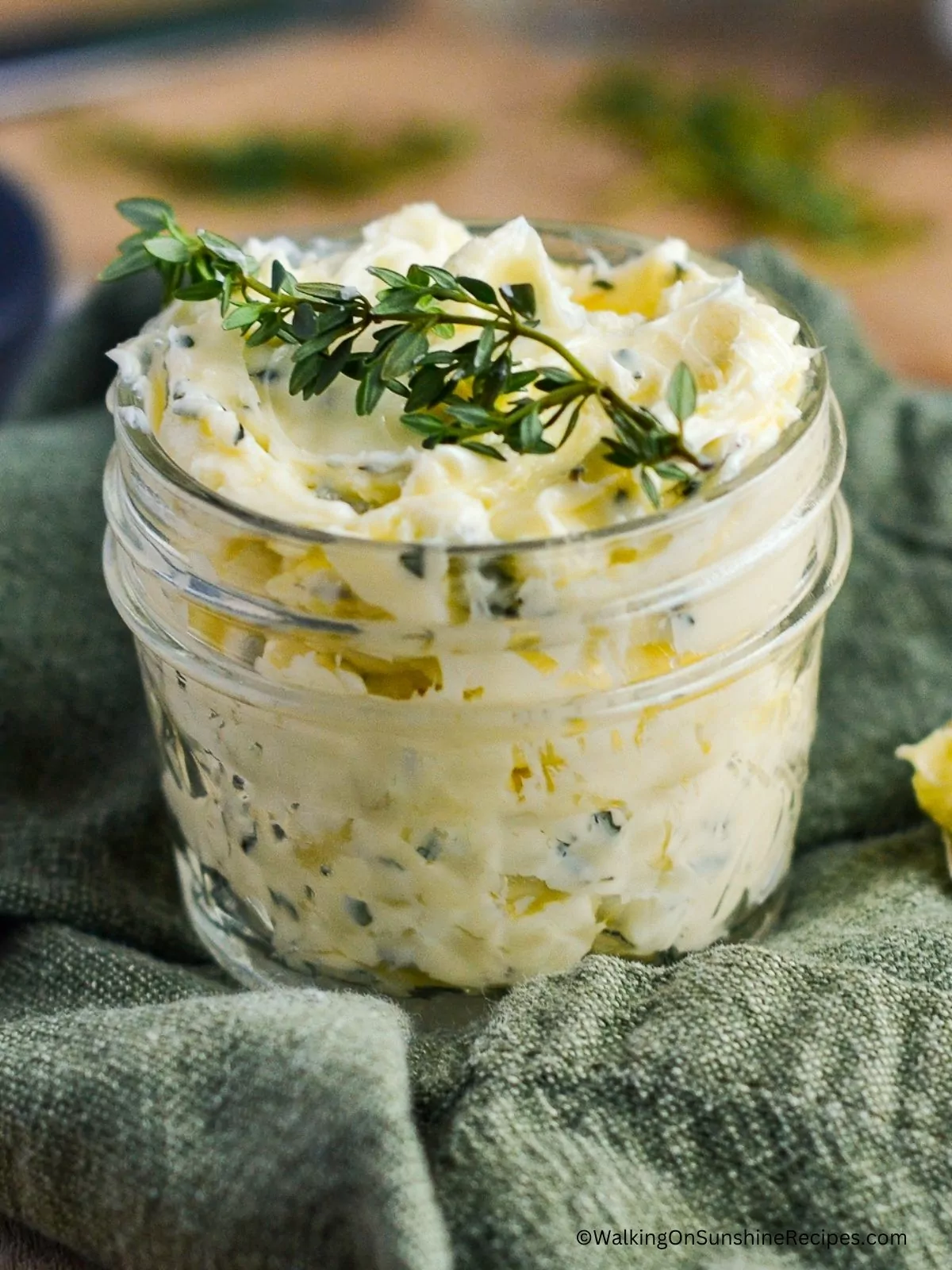 butter with rosemary and garlic in mason jar.