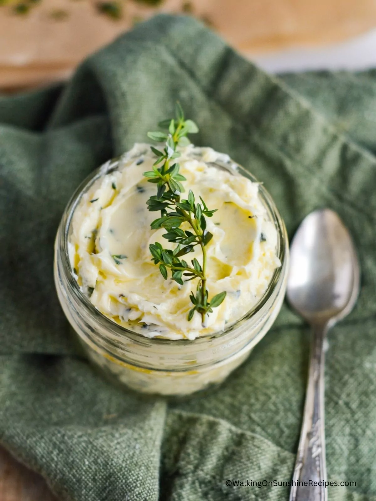 butter with rosemary and garlic in small mason jar.