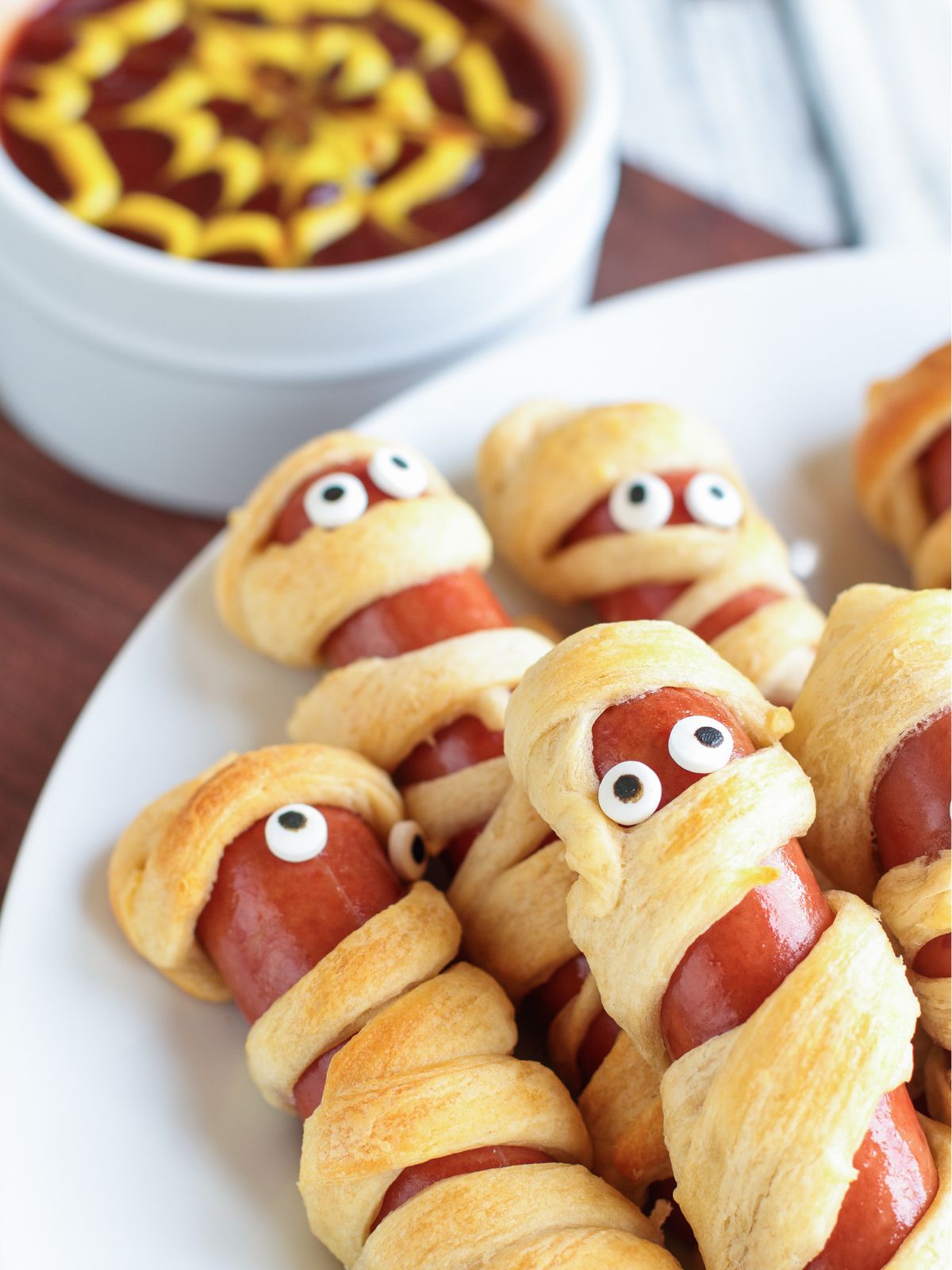 Hot dogs wrapped in crescent roll dough to look like mummies.