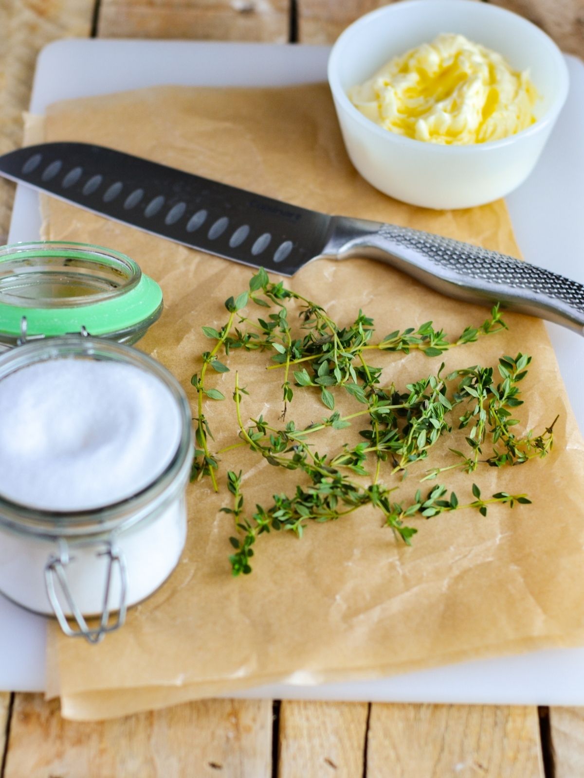 rosemary on parchment paper with salt in mason jar.