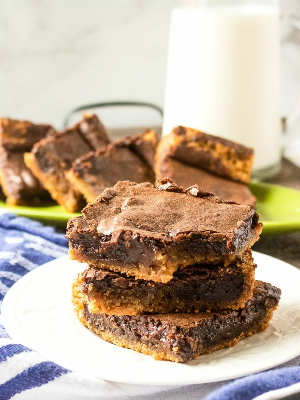 chocolate brownies with peanut butter layer on plate.