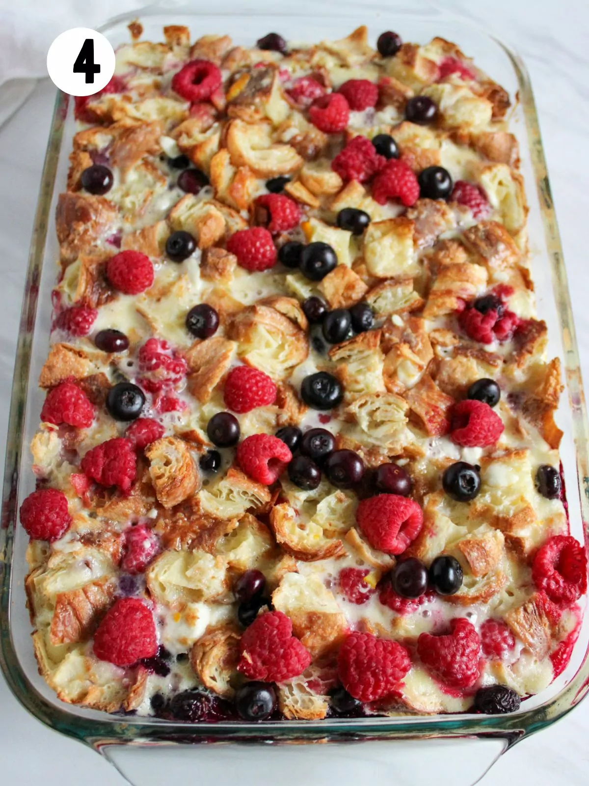 baked breakfast casserole with blueberries and raspberries.