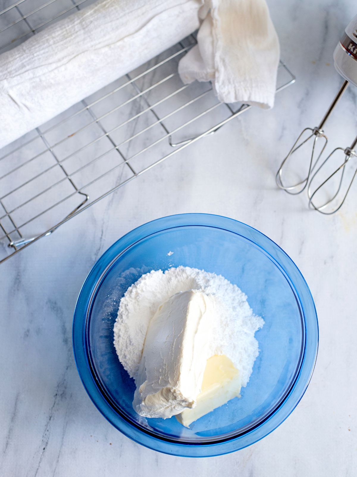 cream cheese, butter and powdered sugar in bowl.