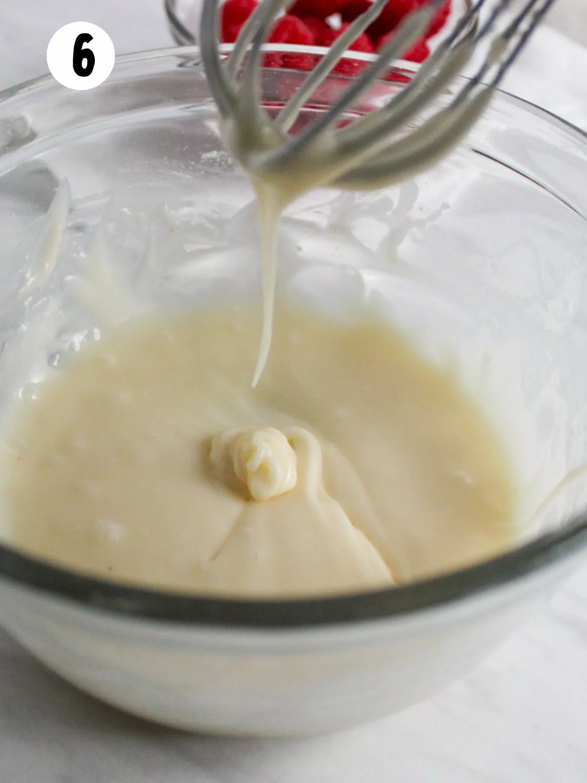 powdered sugar glaze in bowl with whisk.