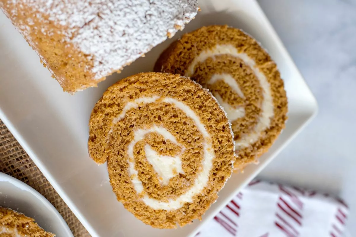 slices of pumpkin roll served on a white platter