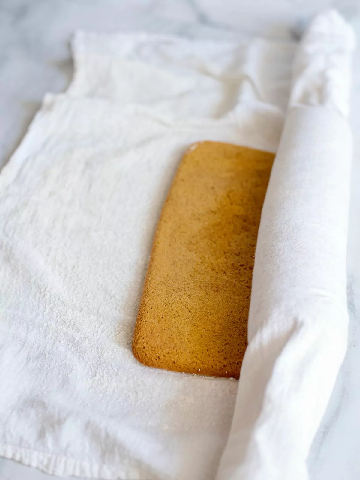 roll baked pumpkin cake in dish towel.