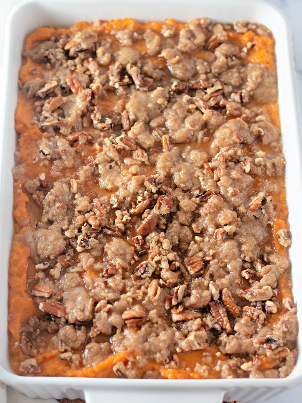 baked Thanksgiving casserole with sweet potatoes and brown sugar crumble.
