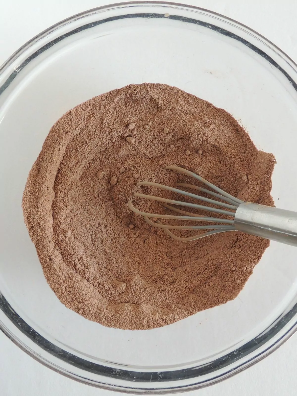 brownie mix in bowl with wire whisk.