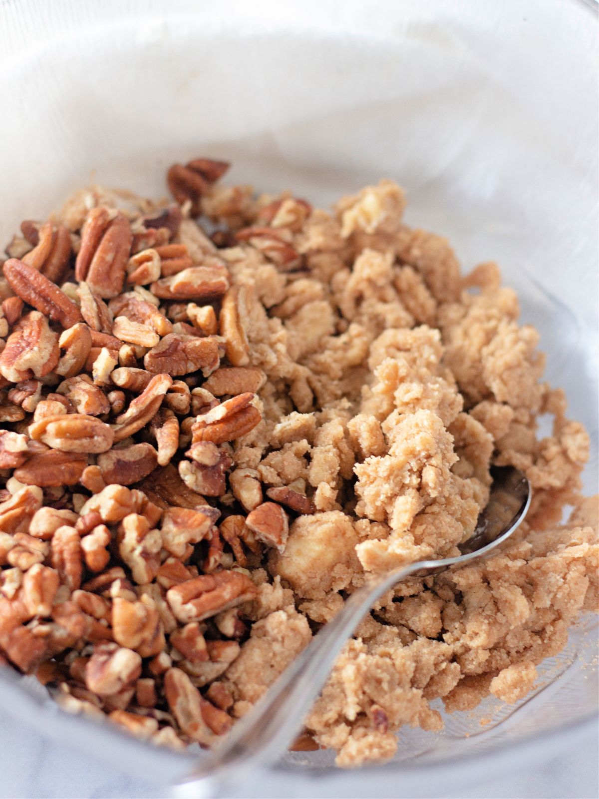 brown sugar crumble in bowl with spoon.
