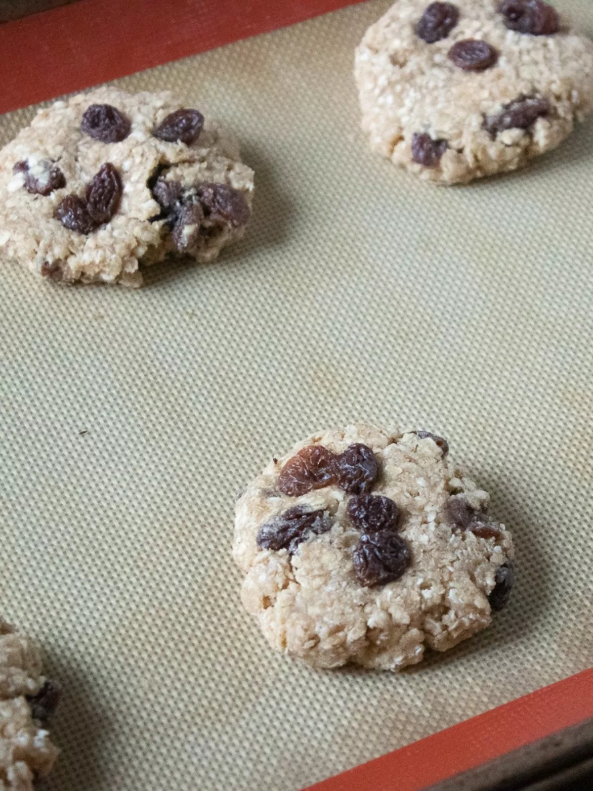 oatmeal raisin cookies on silpat baking tray.