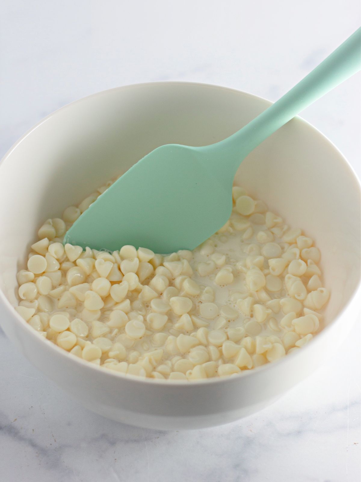 melted white chocolate chips in bowl.