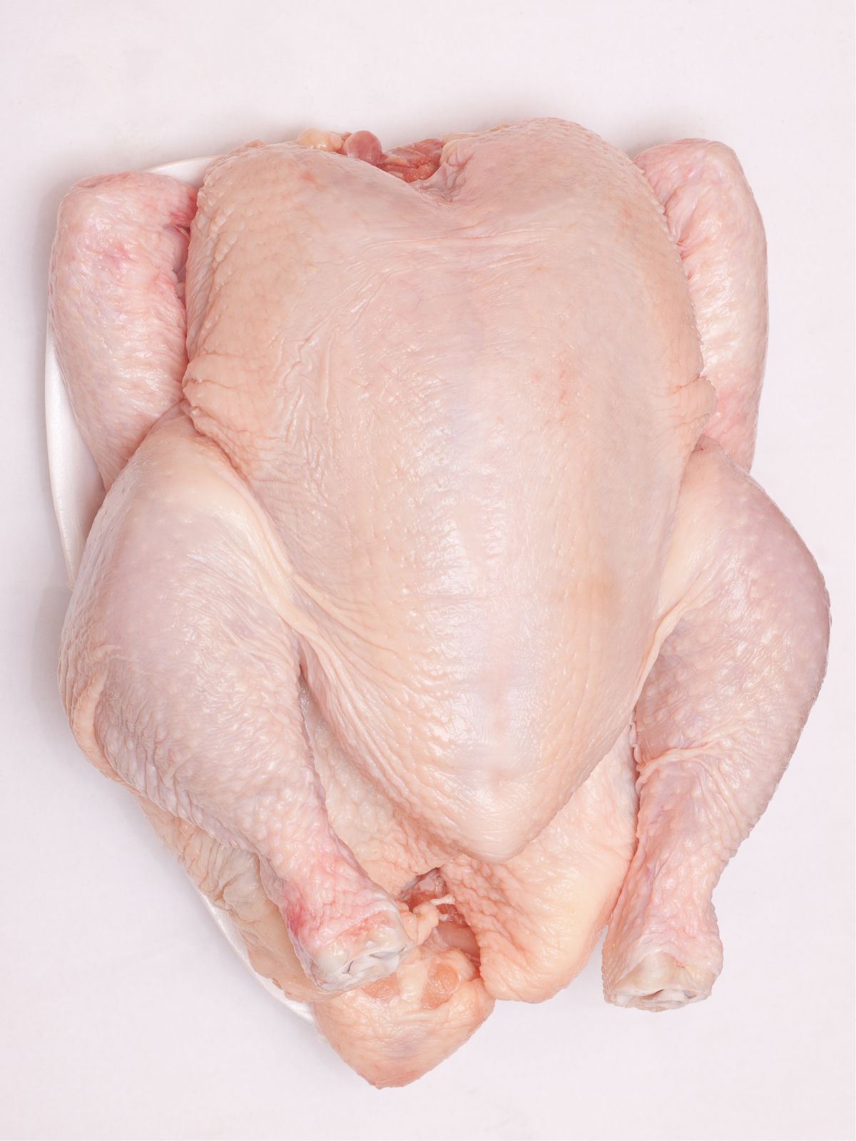 raw turkey on plate.