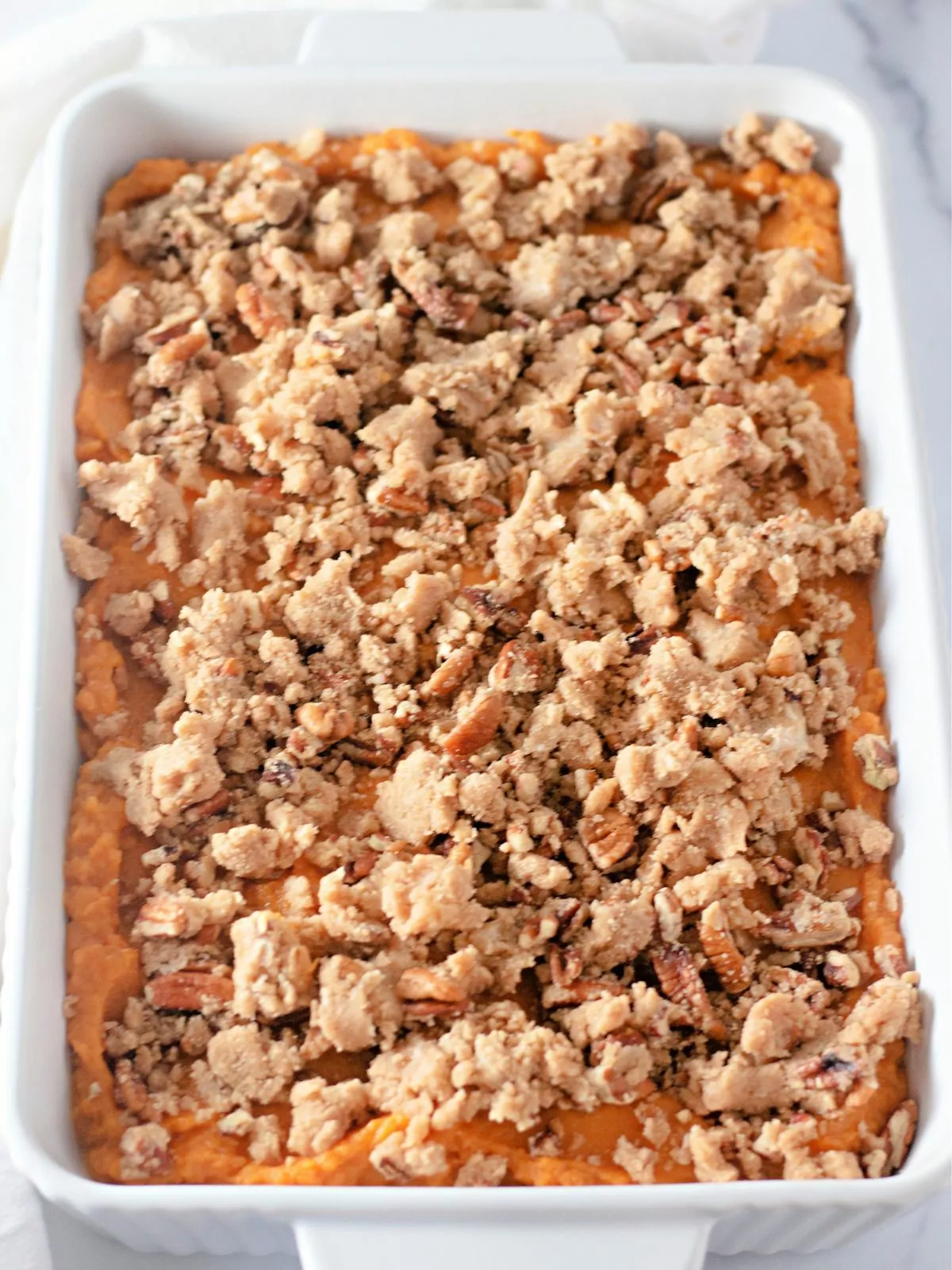 brown sugar crumble on top of unbaked sweet potato casserole.