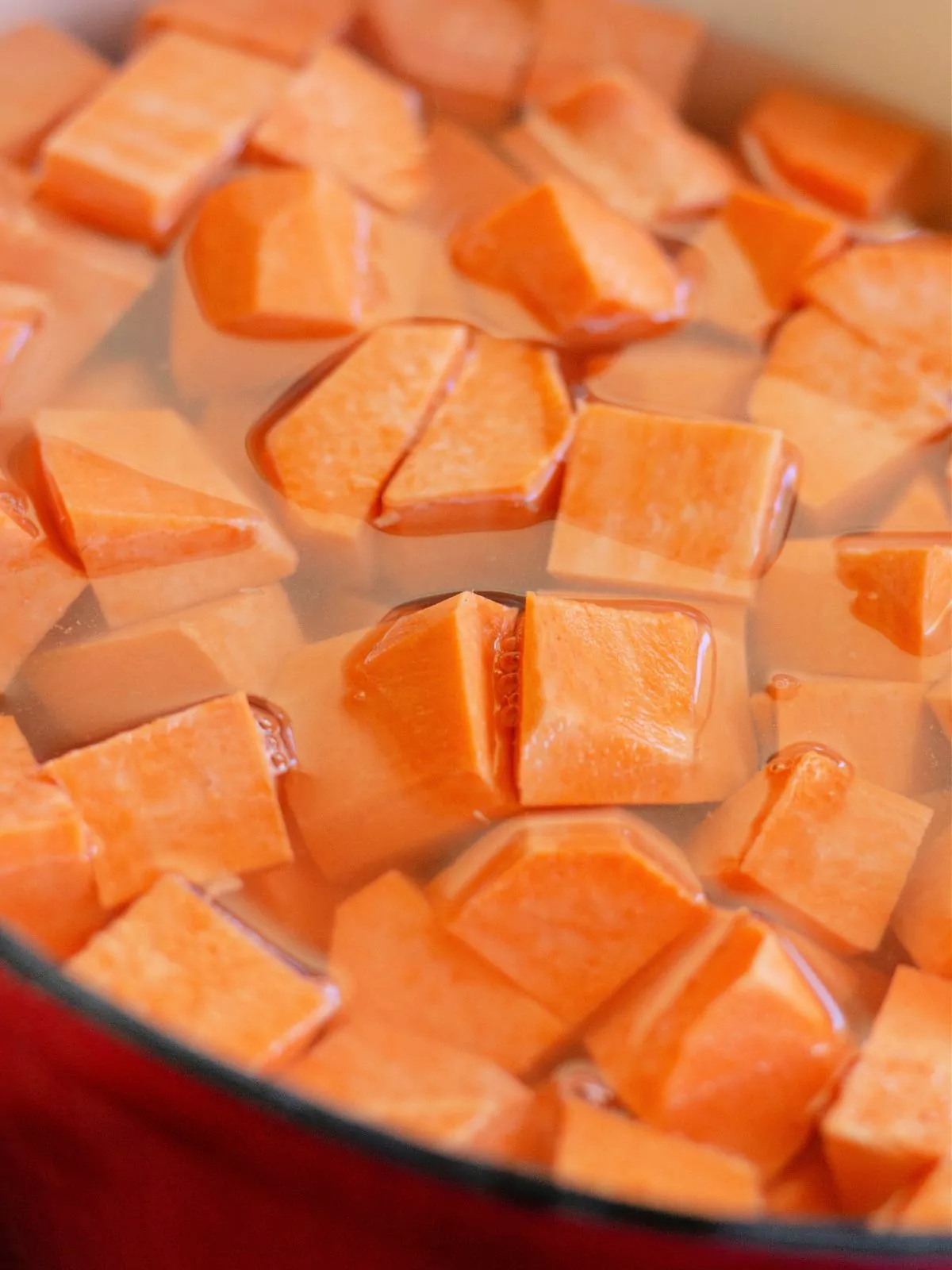 cubed sweet potatoes in pot with water.