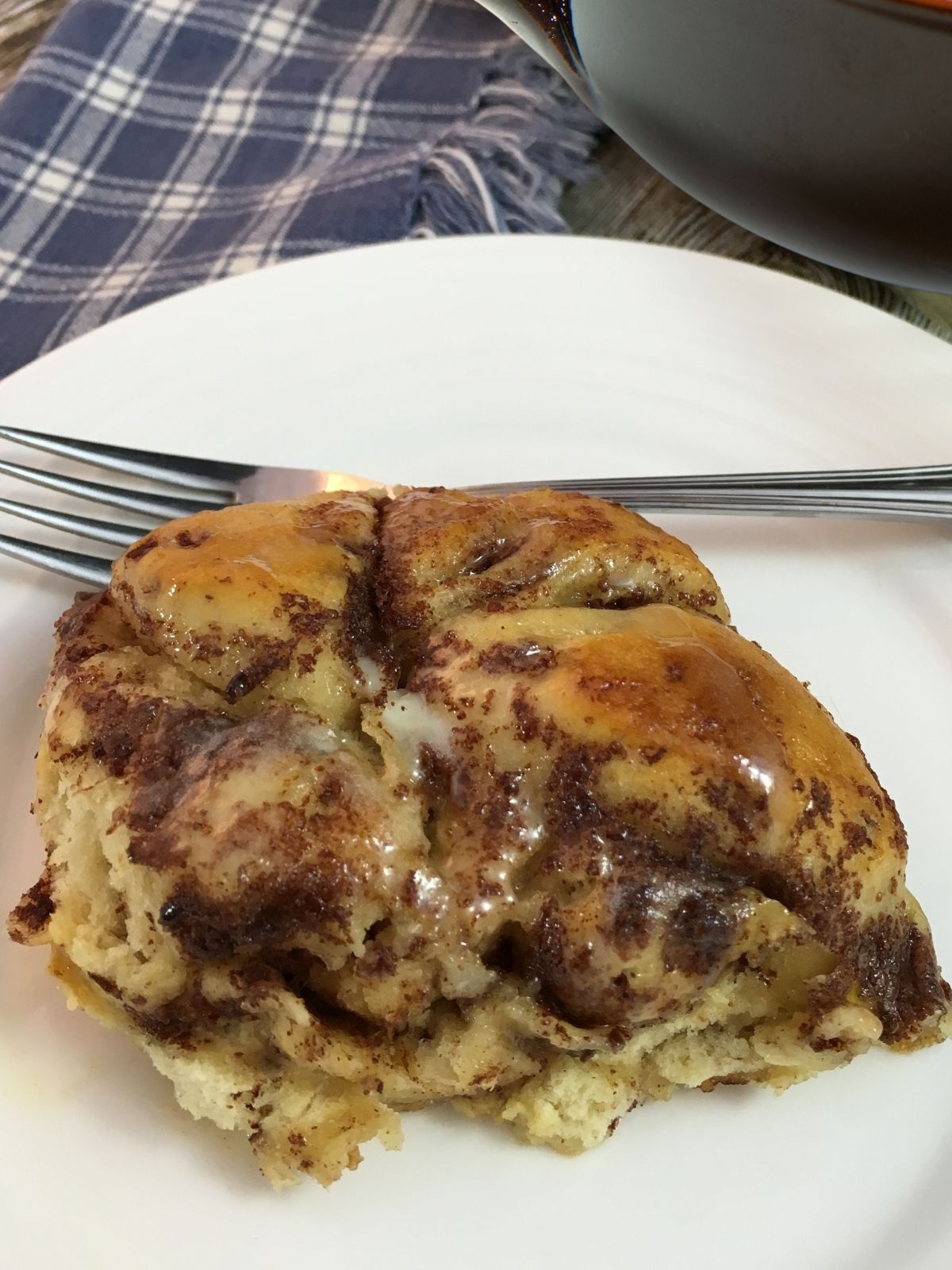 Cinnamon crock pot casserole served on plate with fork.