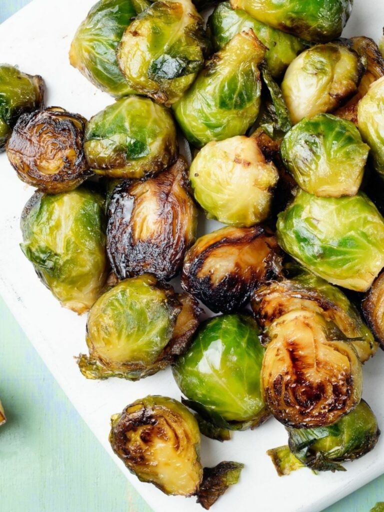 Carmelized Brussels sprouts on white plate served.