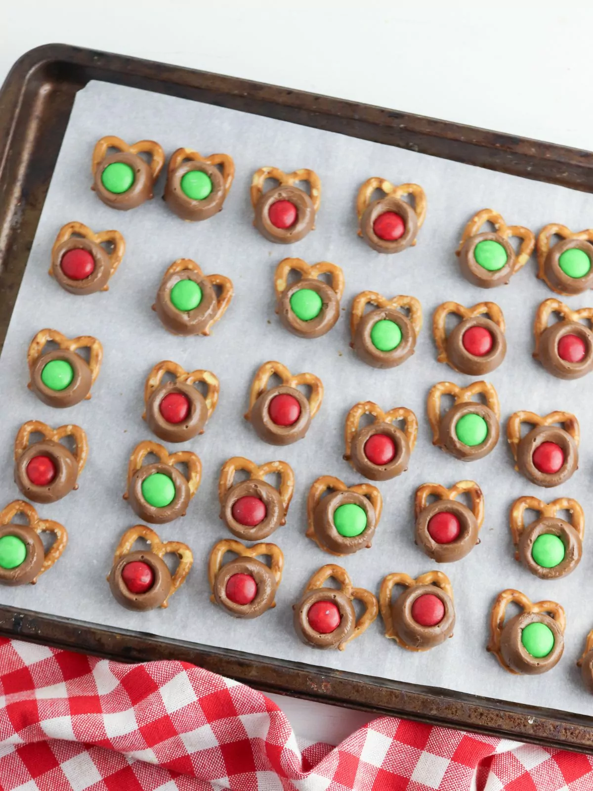 Add red and green M&Ms to the tops of melted Rolo candies.