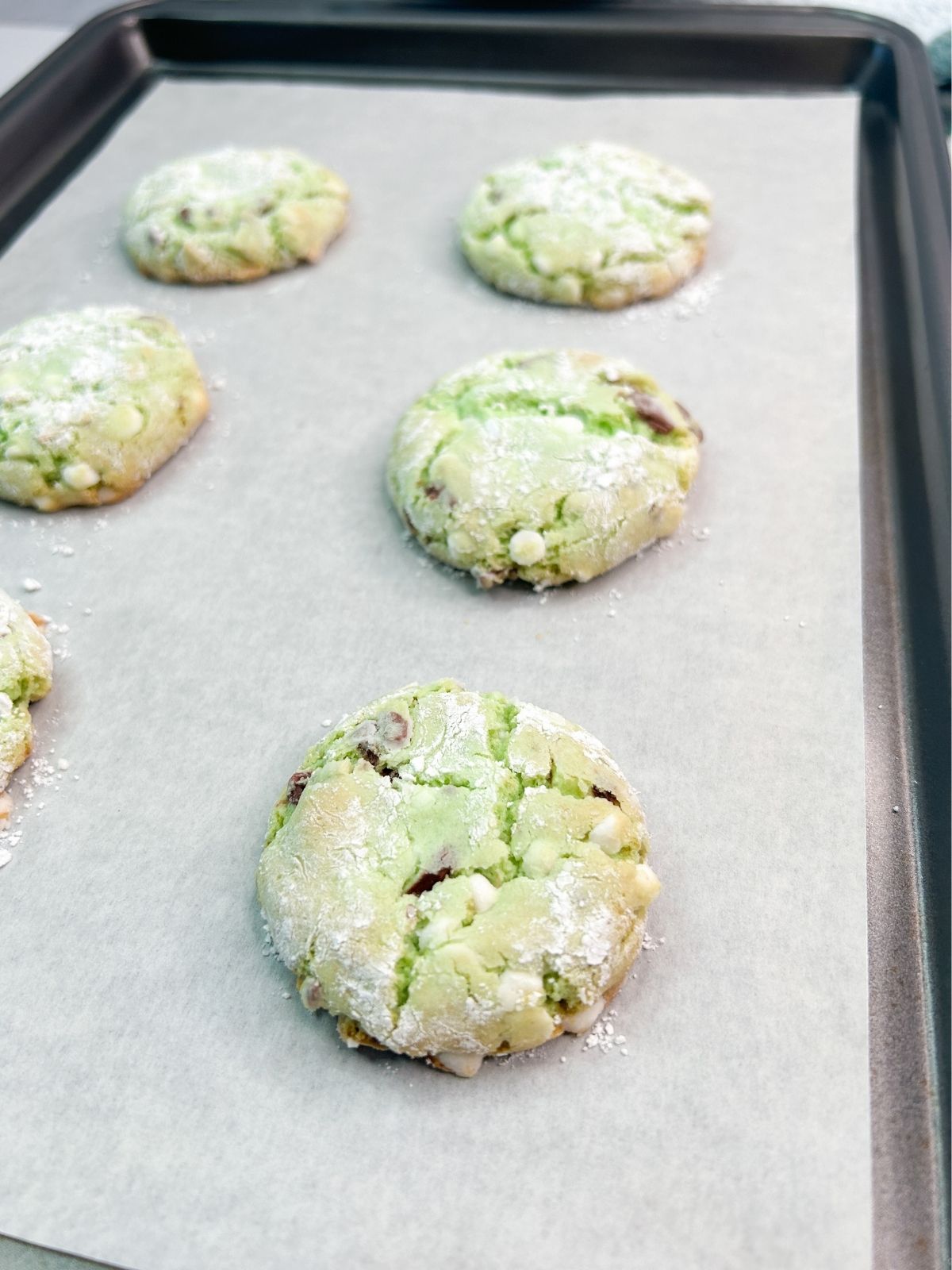 Baked cookies on tray with parchment paper.