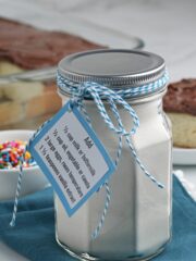 cake mix in a mason jar with blue gift tag.