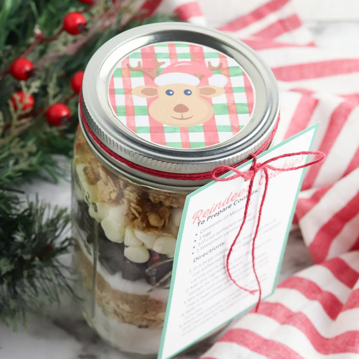 Reindeer cookies in a jar with label and red twine.