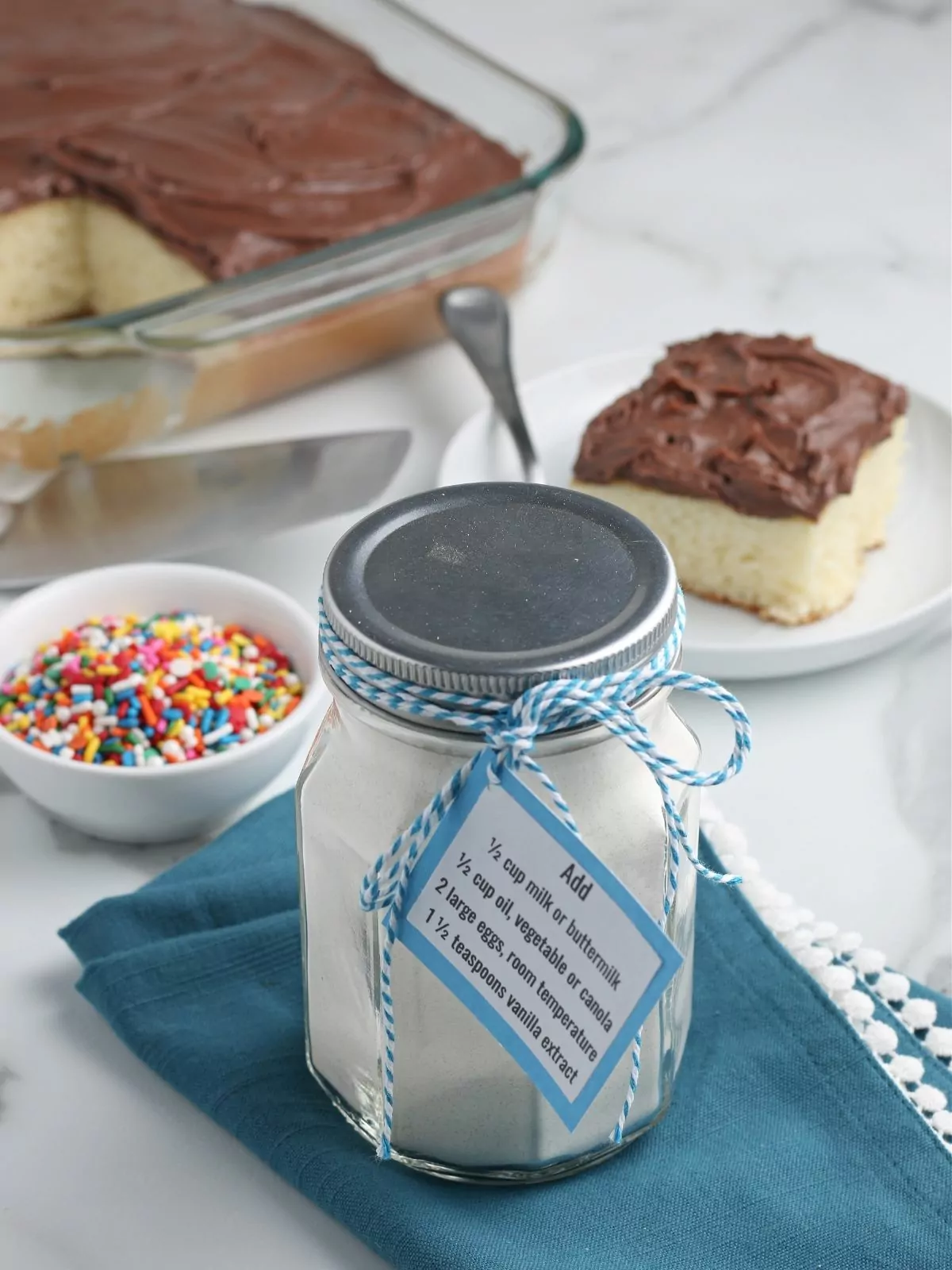 cake mix in a mason jar with homemade cake baked in background.