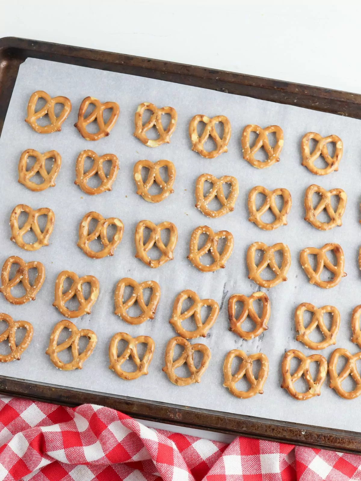 Lay pretzel twists on baking tray with parchment paper.