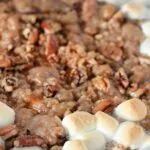 Sweet Potato Casserole with pecans and marshmallows in casserole dish baked.