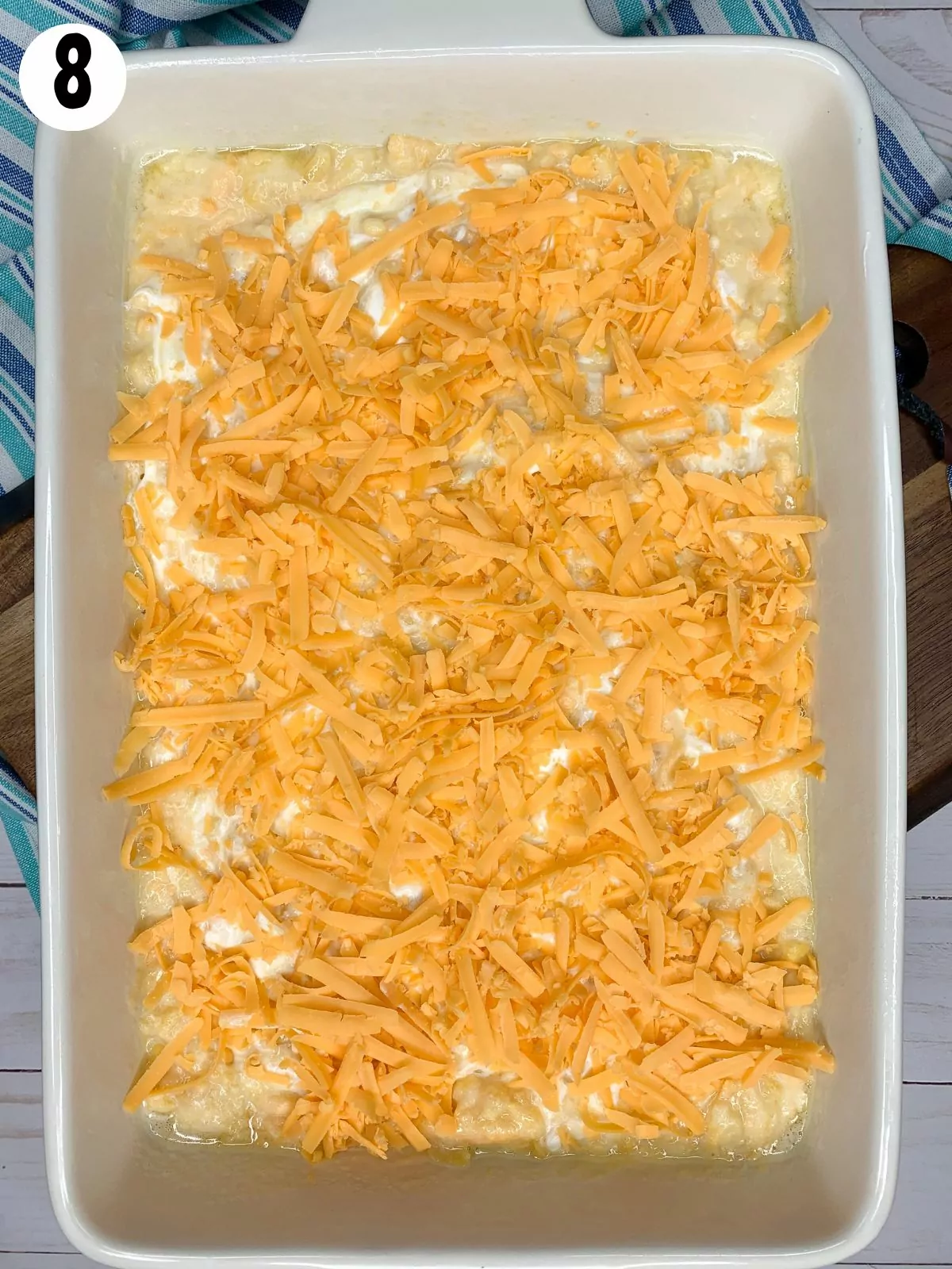Add cheddar cheese to top of casserole dish.