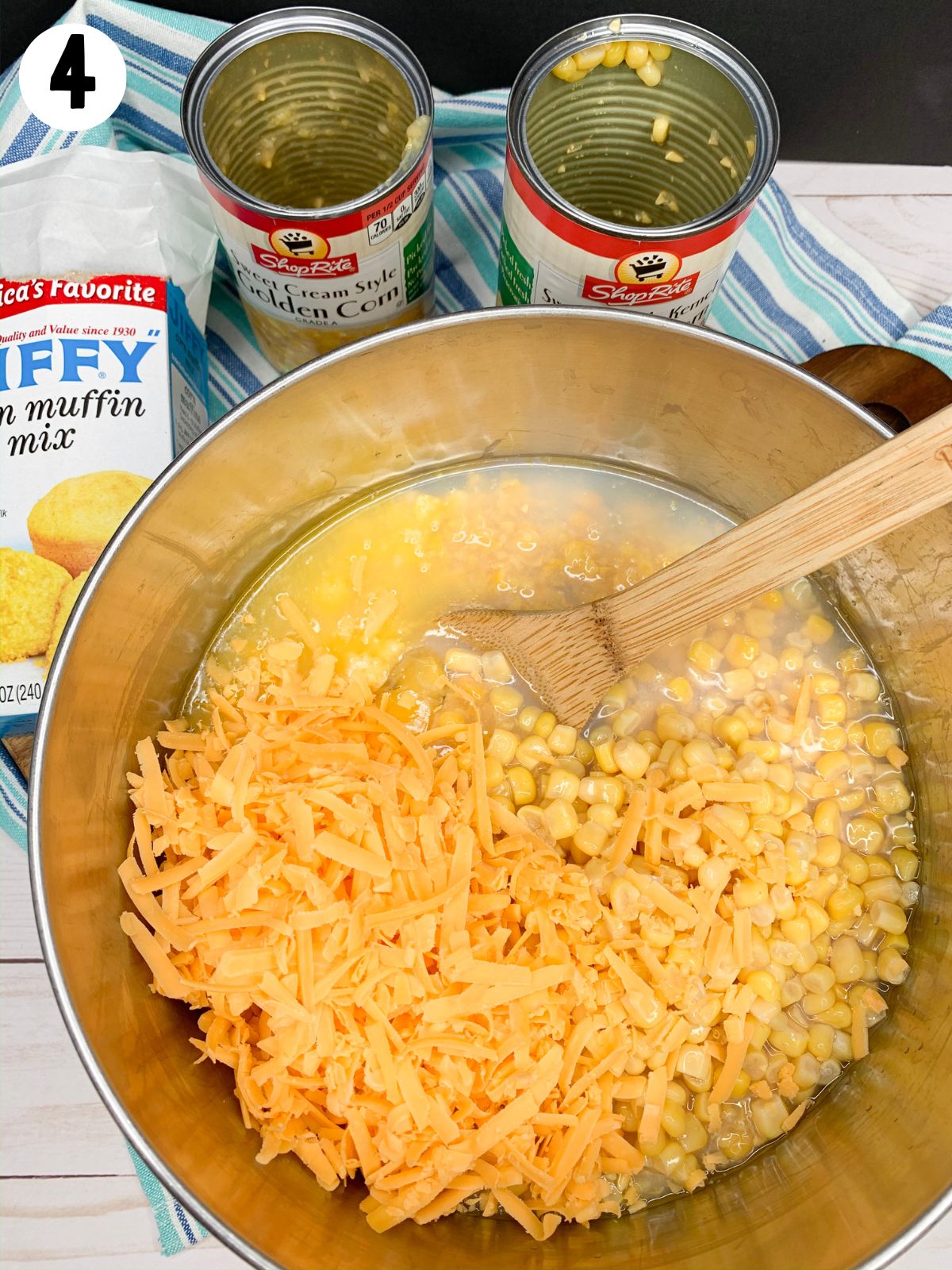 Add cheddar cheese to muffin mix and corn.