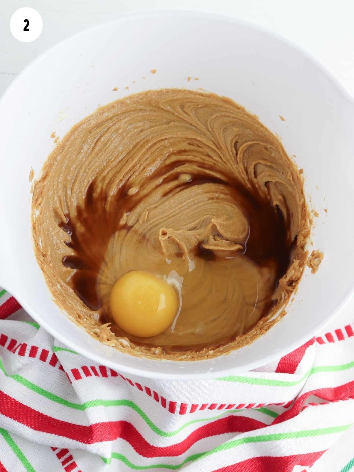 Add egg and vanilla to sugar butter mixture in white bowl.