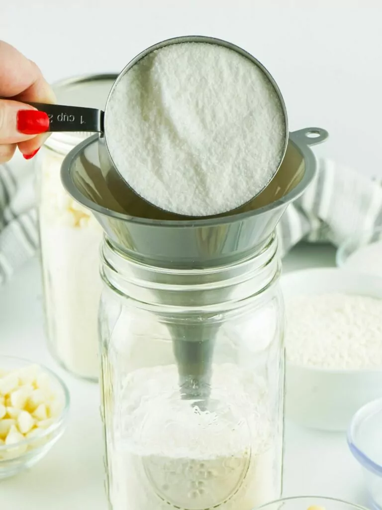 add sugar with funnel to mason jar.