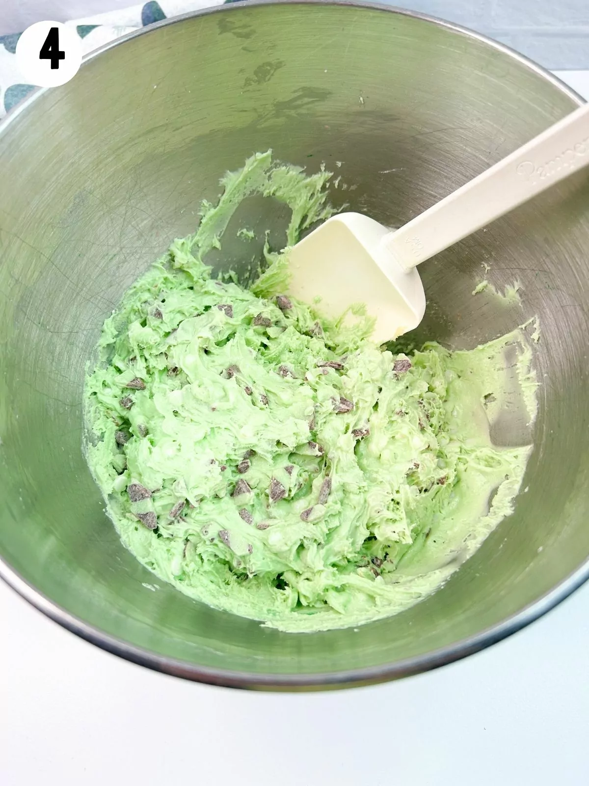 green tinted cake mix cookie batter in bowl.