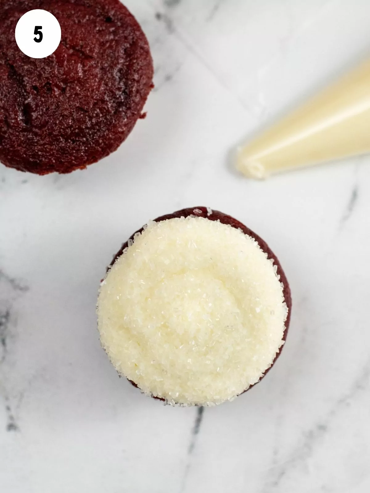 frosted red velvet cupcakes with sanding sugar.