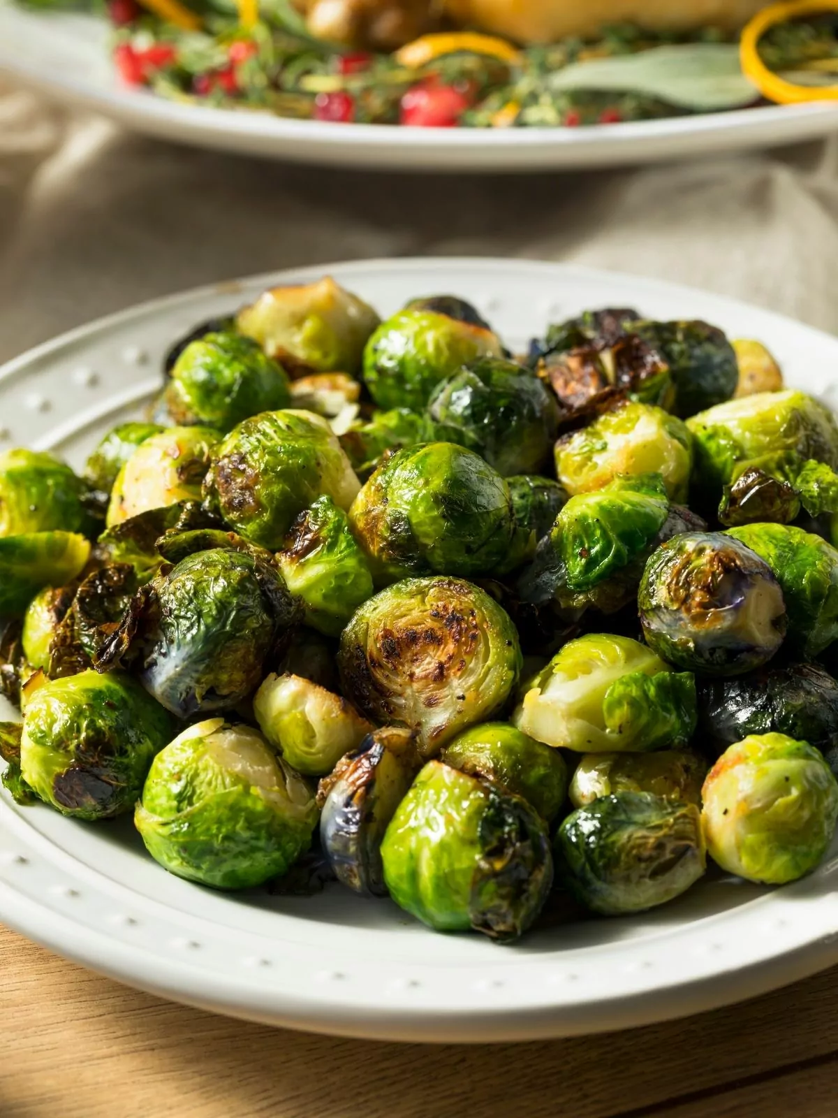 Brussels sprouts roasted and served on white plate.