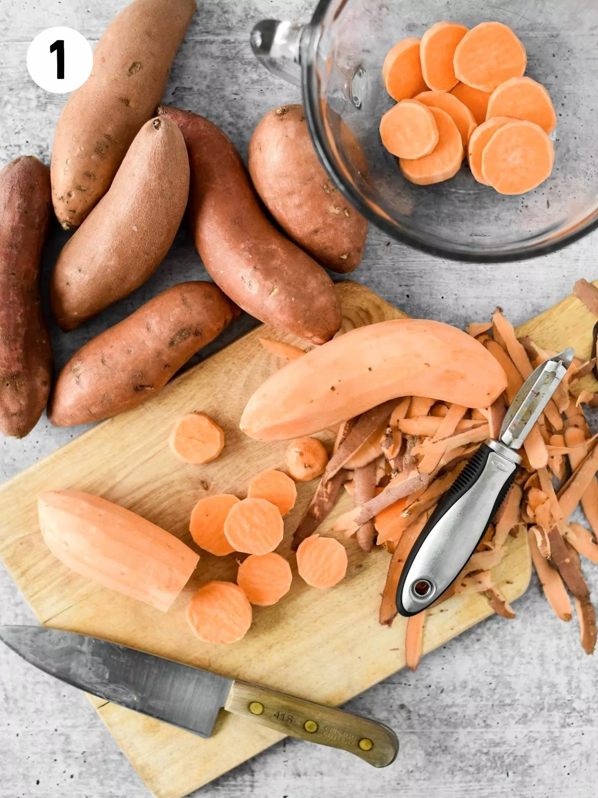 peeling sweet potatoes on cutting board.